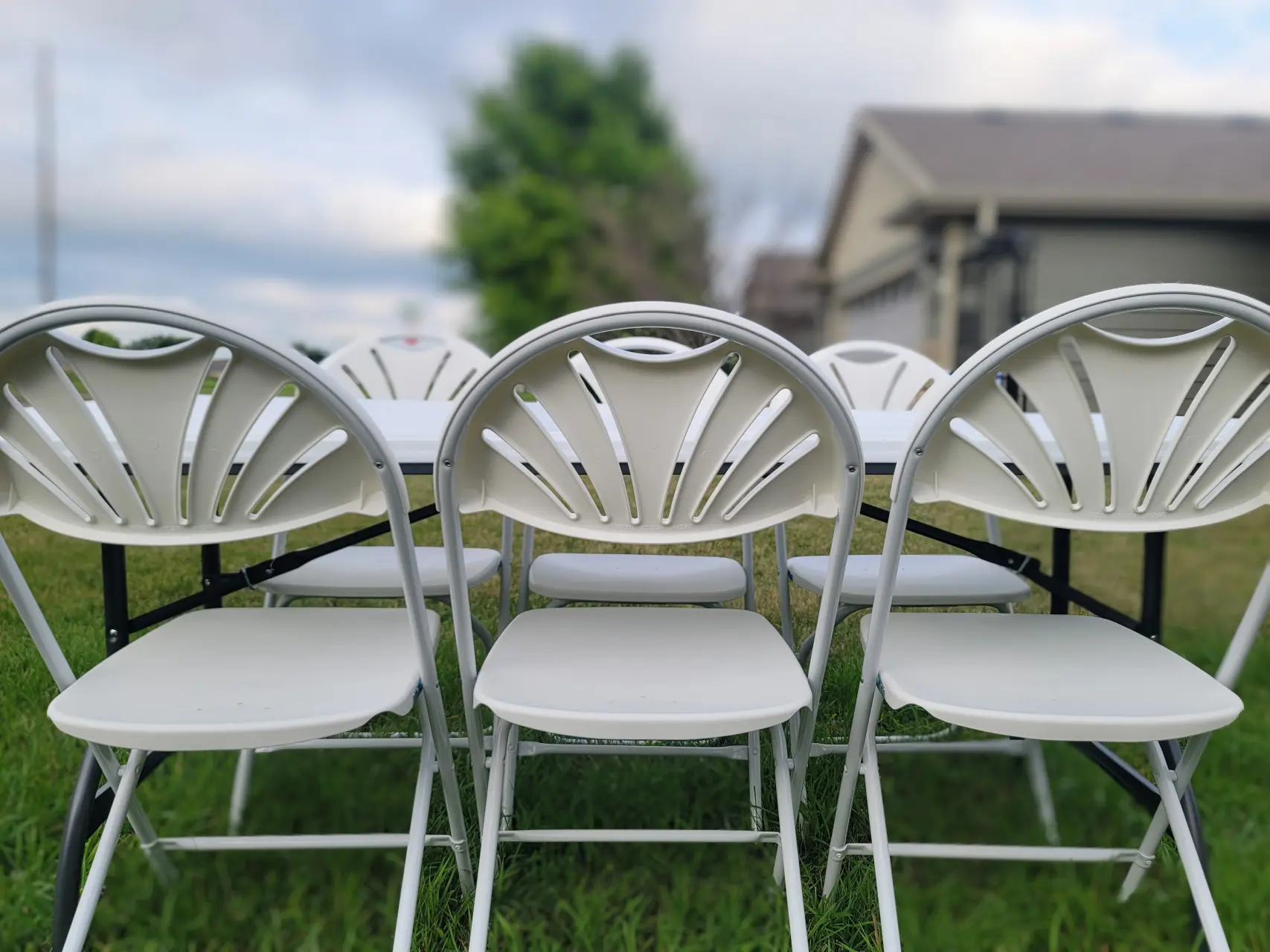 three white fanback chairs